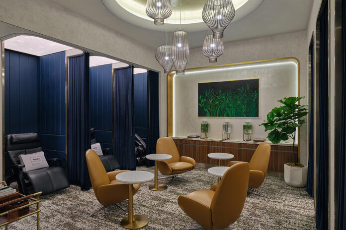 The LAX Delta One Lounge wellness room features eight private relaxation pods equipped with zero-gravity chairs and full-body massage chairs.