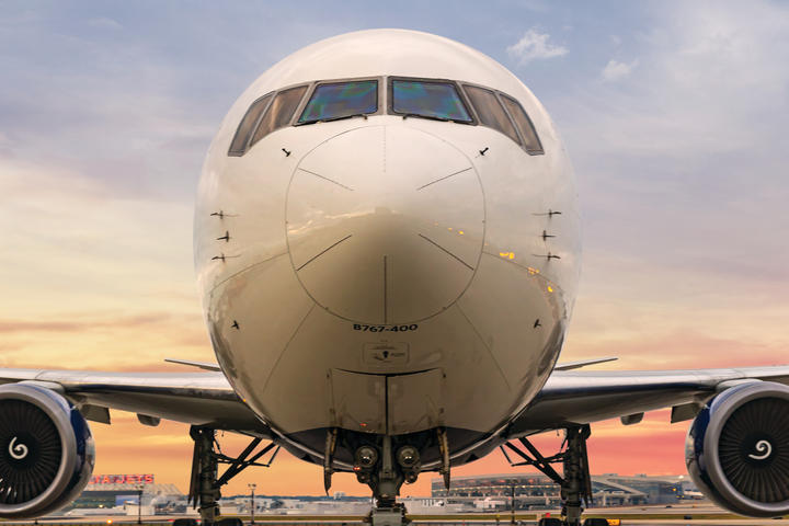 Delta's Boeing 767-400 stands forward facing with a gradient sky background. 