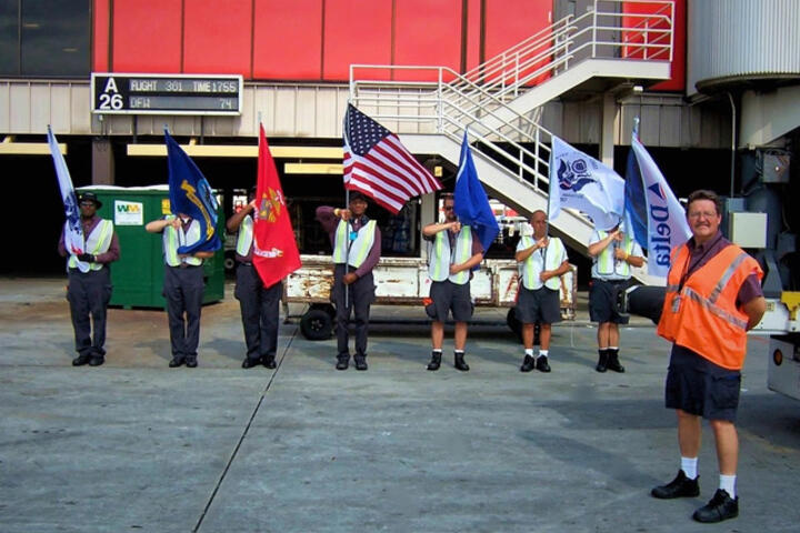 Honor Guard members standing in line with flags