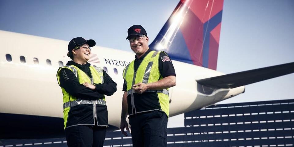 Delta TechOps employees standing in front of an aircraft