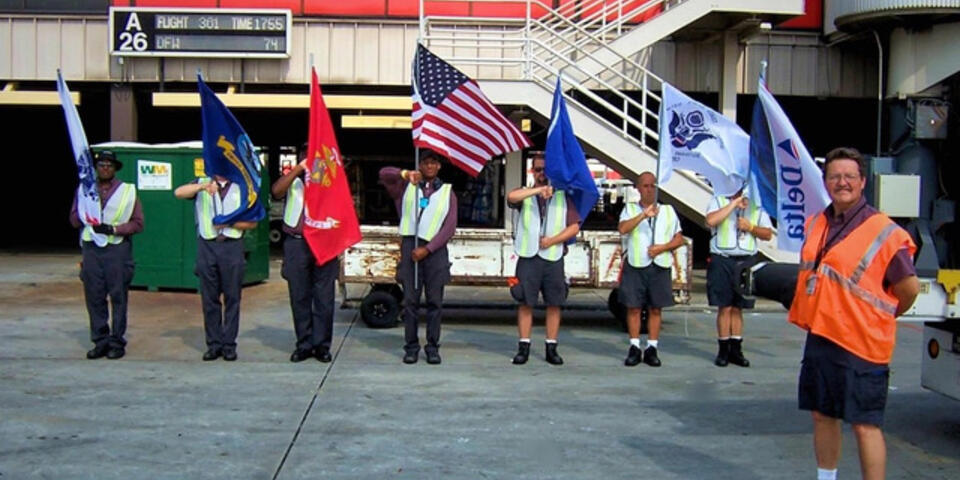 Honor Guard members standing in line with flags